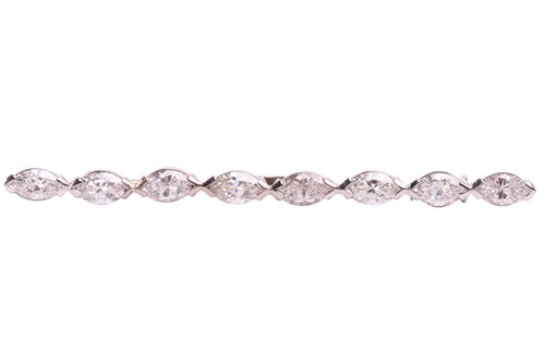 Lot 223 - A diamond bar brooch, elegantly set with a row...