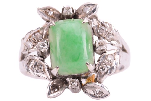 Lot 102 - A jade and diamond ring, set with a central...