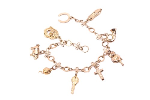 Lot 274 - A charm bracelet with various charms, some...