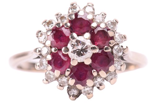 Lot 220 - A ruby and diamond cluster ring, set with...