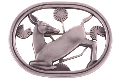 Lot 334 - Georg Jensen - a brooch depicting a kneeling...