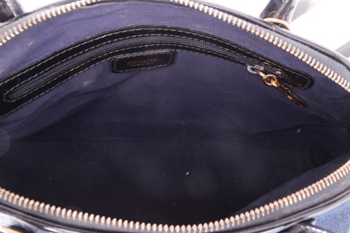 Lot 11 - An Escada bowler bag in denim with black...