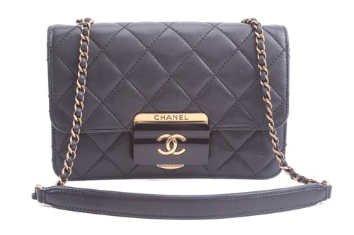 Lot 48 - Chanel - a mini Beauty Lock flap bag in black...
