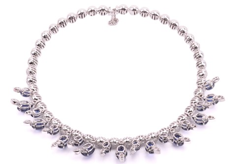 Lot 323 - A diamond and sapphire fringe choker by Stefan...