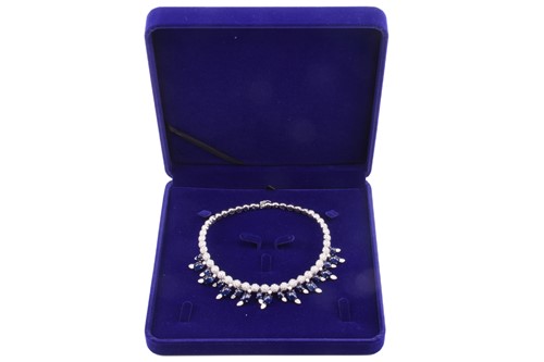 Lot 323 - A diamond and sapphire fringe choker by Stefan...