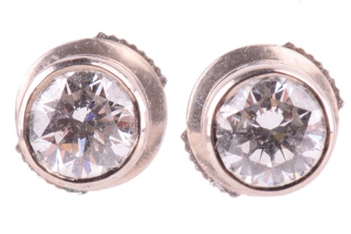 Lot 258 - A pair of diamond stud earrings, each set with...