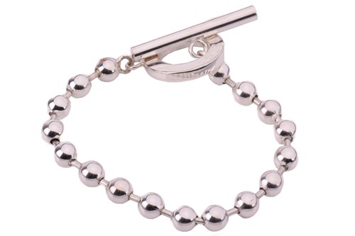 Lot 143 - Gucci. A Boule chain bracelet with a T bar...