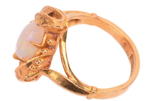 Lot 27 - An opal ring, set with white opal in a foliate...