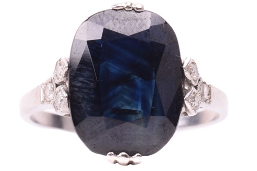 Lot 105 - A sapphire solitaire ring features a...