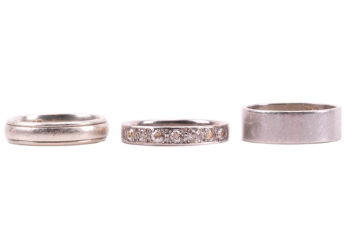 Lot 264 - Two wedding bands and an eternity ring. The...