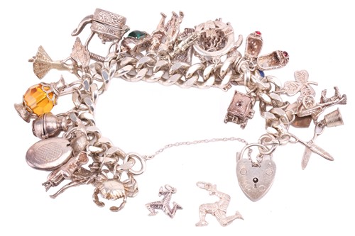 Lot 13 - A silver charm bracelet, the silver curb chain...