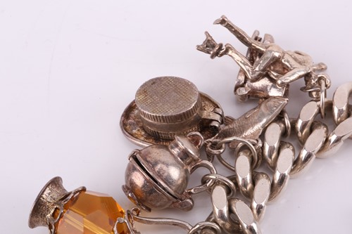 Lot 13 - A silver charm bracelet, the silver curb chain...