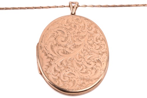 Lot 243 - A 9ct gold locket on a chain, the oval locket...