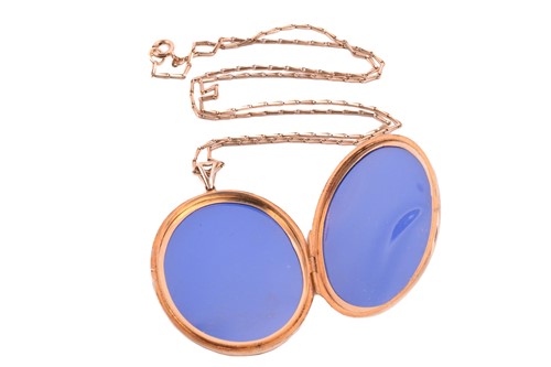 Lot 243 - A 9ct gold locket on a chain, the oval locket...