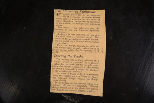 Lot 75 - A lacquer-cased Japanese bronze mirror, with...