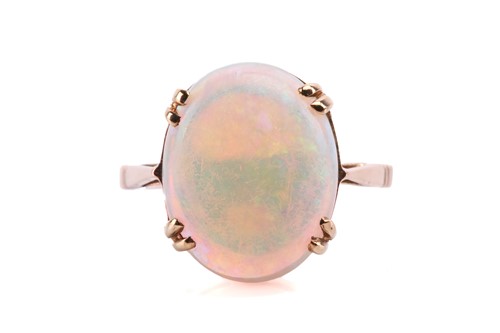 Lot 94 - An opal solitaire ring, featuring an oval...