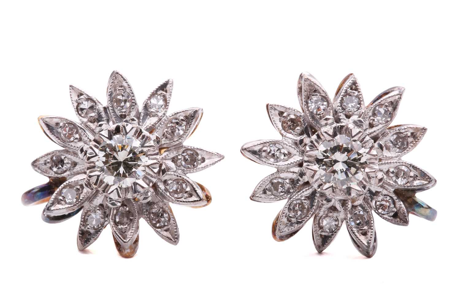 Lot 125 - A pair of diamond daisy head earrings, each...