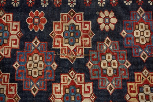 Lot 179 - An antique Armenian Erivan rug with red ground...