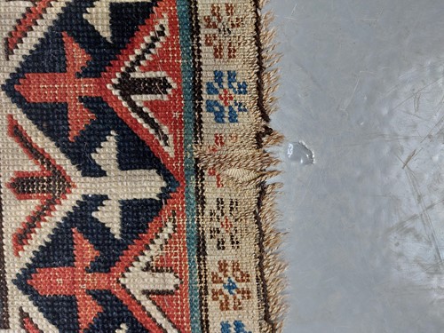 Lot 179 - An antique Armenian Erivan rug with red ground...