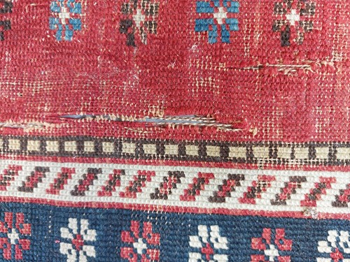 Lot 179 - An antique Armenian Erivan rug with red ground...