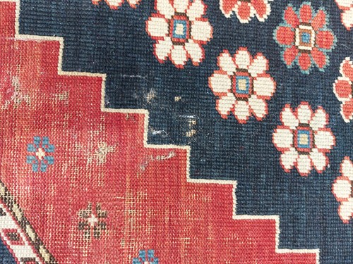 Lot 179 - An antique Armenian Erivan rug with red ground...