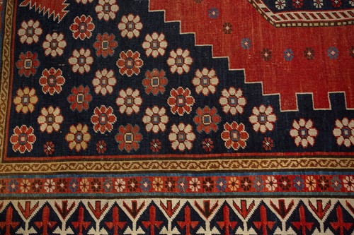 Lot 179 - An antique Armenian Erivan rug with red ground...