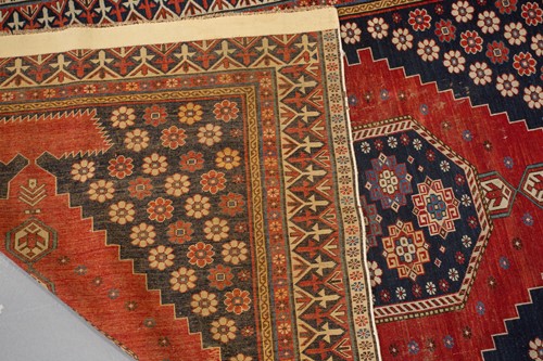 Lot 179 - An antique Armenian Erivan rug with red ground...