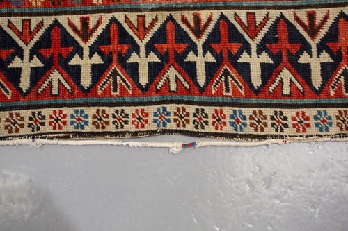 Lot 179 - An antique Armenian Erivan rug with red ground...