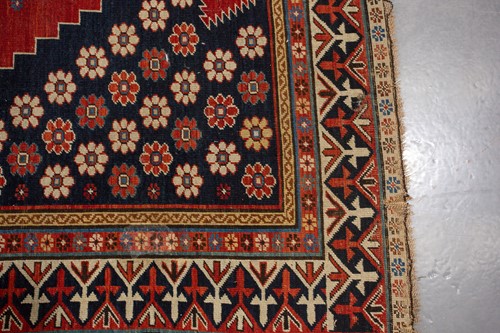 Lot 179 - An antique Armenian Erivan rug with red ground...