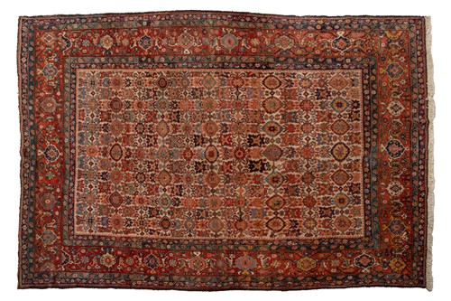 Lot 171 - An old ivory ground Heriz carpet with an...