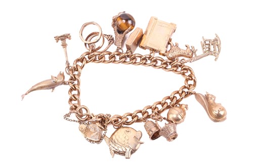 Lot 23 - A curb link charm bracelet with hallmarks for...