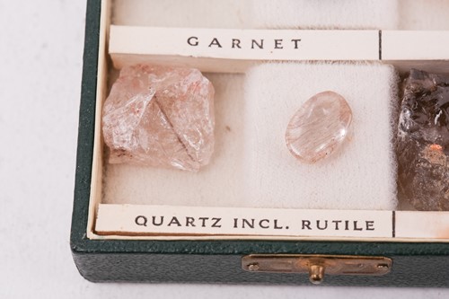 Lot 64 - A case of gem and mineral specimens, featuring...