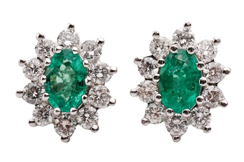 Lot 14 - A pair of 18 carat white gold, emerald and...