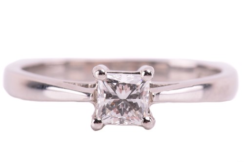 Lot 23 - A single stone diamond ring; the princess...