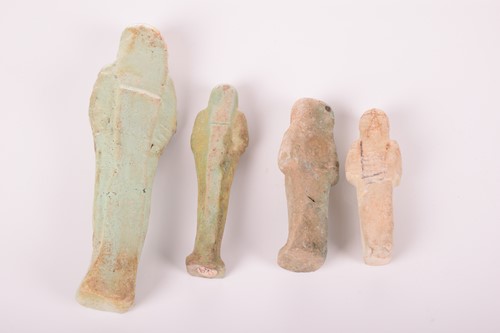 Lot 242 - An Egyptian faience shabti with a mottled...