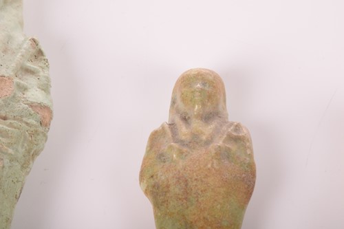 Lot 242 - An Egyptian faience shabti with a mottled...