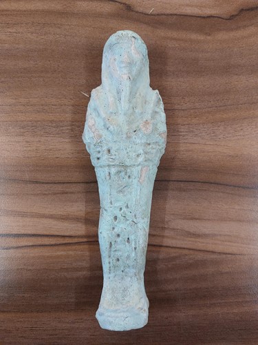 Lot 242 - An Egyptian faience shabti with a mottled...