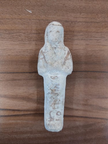 Lot 242 - An Egyptian faience shabti with a mottled...