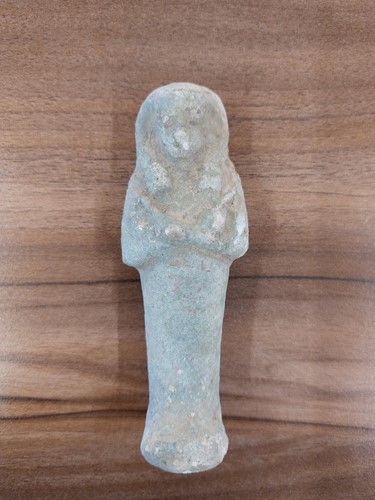 Lot 242 - An Egyptian faience shabti with a mottled...