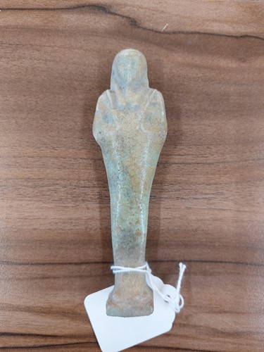 Lot 242 - An Egyptian faience shabti with a mottled...