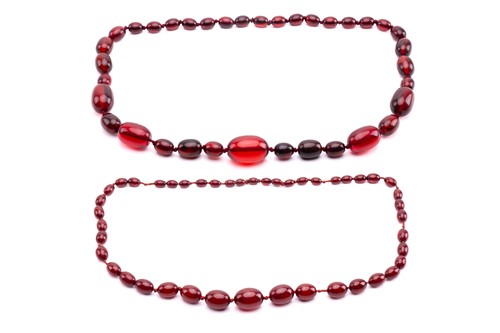 Lot 273 - A ruby amber necklace, the oval beads...