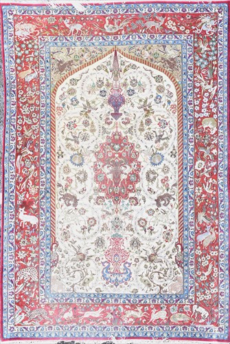 Lot 47 - A Persian red and cream ground rug polychrome...