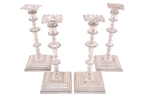 Lot 449 - A matched set of four George III cast silver...