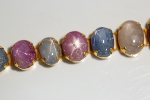 Lot 204 - A star corundum bracelet, articulated links...