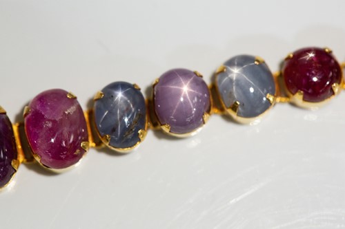 Lot 204 - A star corundum bracelet, articulated links...