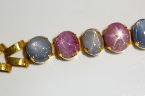 Lot 204 - A star corundum bracelet, articulated links...