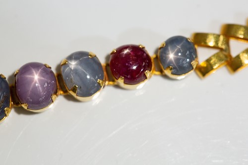 Lot 204 - A star corundum bracelet, articulated links...