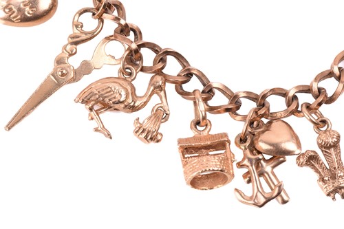 Lot 261 - A gold charm bracelet with hallmarks for 9ct...