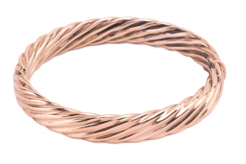 Lot 111 - A hinged bangle in twisted rope design, the...