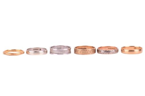 Lot 24 - A collection of six gold wedding bands;...